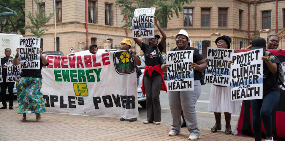 Activists from Earthlife Africa demonstrate outside the court during the hearing of the first Thabametsi coal-fired power station court case in March 2017. Image: James Oatway for CER